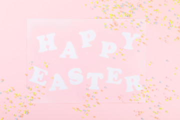 Happy Easter Greeting card with the inscription on a pink paper background.Concept of festive greetings