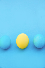 Easter blue and yellow eggs on blue background. Greeting Easter Spring Card