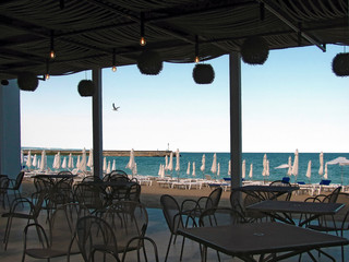View of beach and sea pier from the coastal restaurant. Rest on black sea.