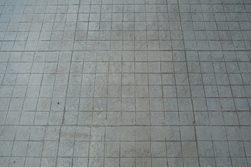 gray concrete ground at walk way. square pattern footpath.