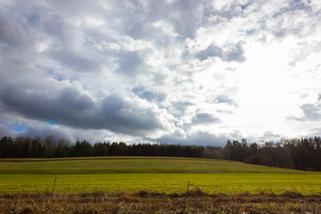 stormy cloudy sky on a green field