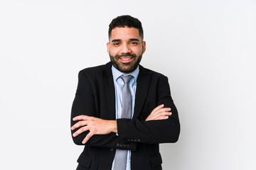 Young latin business woman against a white background isolated who feels confident, crossing arms with determination.
