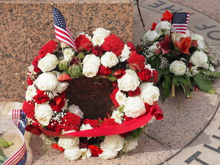 Memorial wreaths with American flag at a war memorial