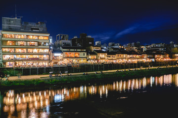 Traditional restaurants and Kamo River reflections at night, Kyoto, Japan