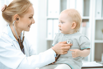 Doctor and patient in hospital. Little girl is being examined by doctor with stethoscope. Medicine concept