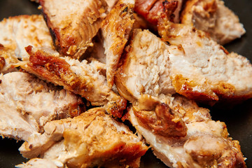 baked meat cut into pieces close up photo