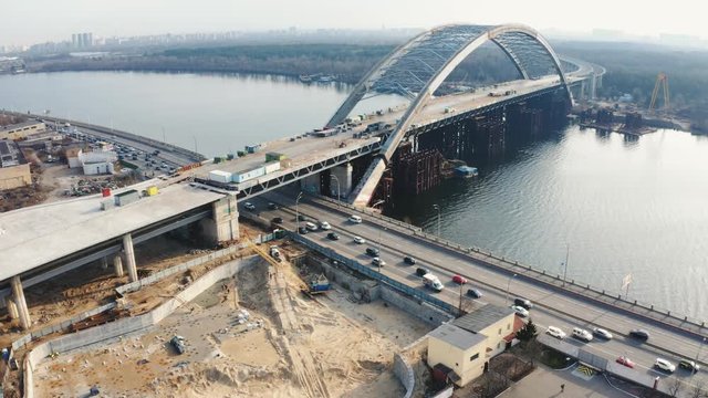 Bridge is under construction. Podilsko-Voskresensky Bridge. Podilskyi Metro Bridge. Orbit aerial view 4k