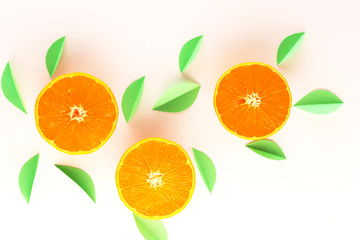 orange slices and green leaves on a white background. exotic background