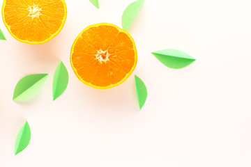 orange slices and green leaves on a white background. exotic background