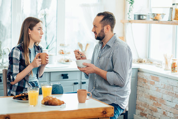 Two calm people having breakfast and talking stock photo