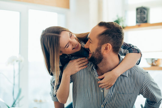 Happy woman hugging her man and smiling stock photo