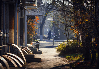 An old street early in a autumn morning lighted by a bright sun.