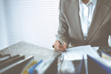 Bookkeeper woman or financial inspector making report, calculating or checking balance, close-up....