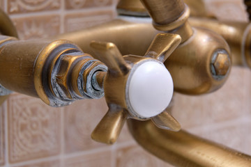  A plaque of lime on a tap of bronze in the bathroom. High calcium content in tap water.