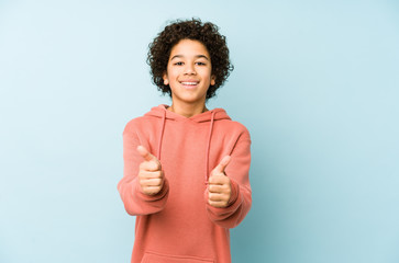 African american little boy isolated with thumbs ups, cheers about something, support and respect...