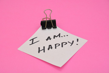 I am happy words written on white paper. Affirmations for every day. Happiness concept