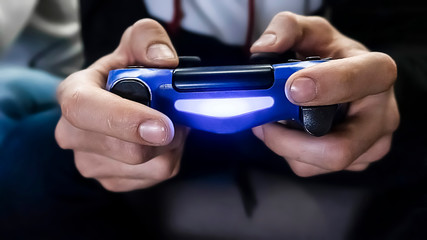 Man hold the gamepad in hands, playing game. One gamer person, close-up