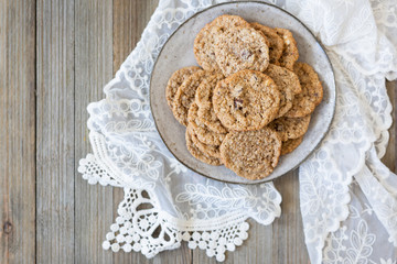 Oatmeal cookies on plate with lace and wood
