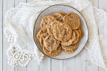 Oatmeal cookies on plate with lace and wood