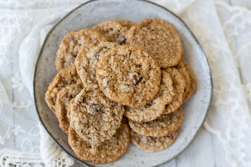 Oatmeal cookies on plate with lace and wood