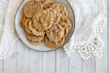 Oatmeal cookies on plate with lace and wood