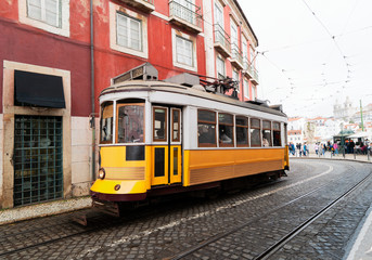 Naklejka na ściany i meble tram on narrow street of Alfama, Lisbon