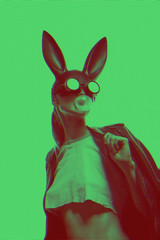masked easter bunny blowing bubble gum bubbles. Easter party concept - obrazy, fototapety, plakaty