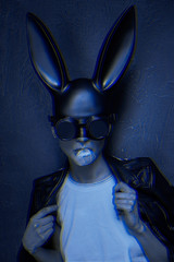 masked easter bunny blowing bubble gum bubbles. Easter party concept
