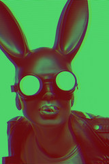 masked easter bunny blowing bubble gum bubbles. Easter party concept