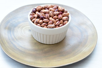 Raw bean grains (Phaseolus vulgaris) displayed in bowl