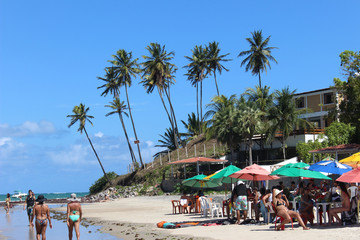 Wakling in the beach with coconuts