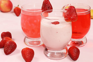 Strawberry smoothie, smoothie, juice or fruit drinks in glasses and ingredients on a sunny table. The concept of detox diet and weight loss, healthy and natural nutrition, bar. Healthy breakfast,