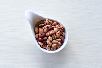 Raw bean grains (Phaseolus vulgaris) displayed in bowl
