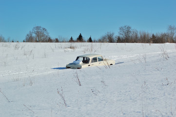 Naklejka premium Snow covered car in the open field