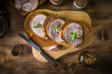 Tasty breakfast - dark bread with baked bacon.