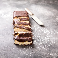 Raw homemade chocolate coconut dessert bounty. Healthy vegan food concept.