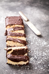 Raw homemade chocolate coconut dessert bounty. Healthy vegan food concept.
