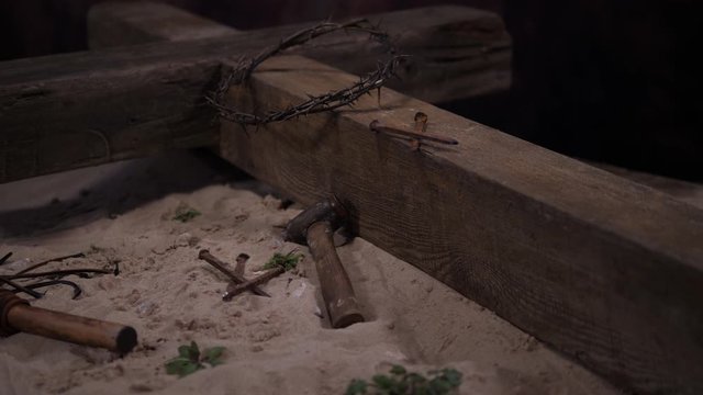 4K: Crown of thorns on Cross of Jesus Christ at Easter. Tracking shot of the crucifixion scene with Nails, Hammer & Whip. Stock Video Clip Footage