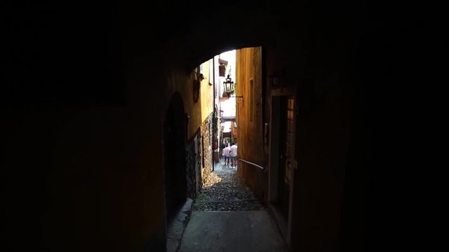 Narrow street in old Varenna, Lake Como Italy. Summer luxury tourism landmark & romantic honeymoon travel destination. 