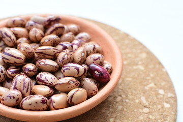 Raw bean grains (Phaseolus vulgaris) displayed in bowl