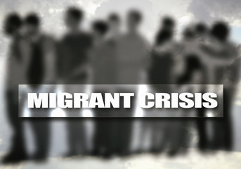 On the poster writes: MIGRANT CRISIS, in the background of silhouettes of migrants, blurred image.