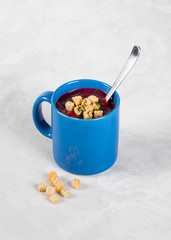 Beetroot soup-puree in a mug on a light background
