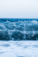 blue wave breaking in the sea.