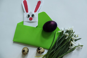 Easter eggs on the background of an envelope and a rabbit