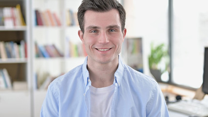 Fototapeta premium Smiling Young Man, Student Looking at Camera