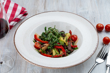 Warm fine dining salad with arugula, avocado and roasted beer stripes