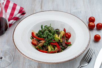 Warm fine dining salad with arugula, avocado and roasted beer stripes