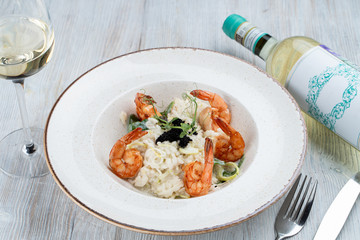 Shrimp risotto with ginger and lemongrass, decorated with black caviar