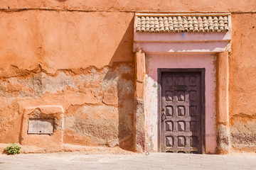Fototapeta na wymiar Image of wooden old door and part of the house in Morocco.