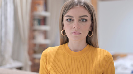 Portrait of Serious Young Woman Looking at the Camera